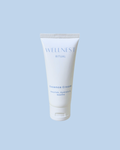 Tube of Wellness Ritual Essence Cream on a light blue background