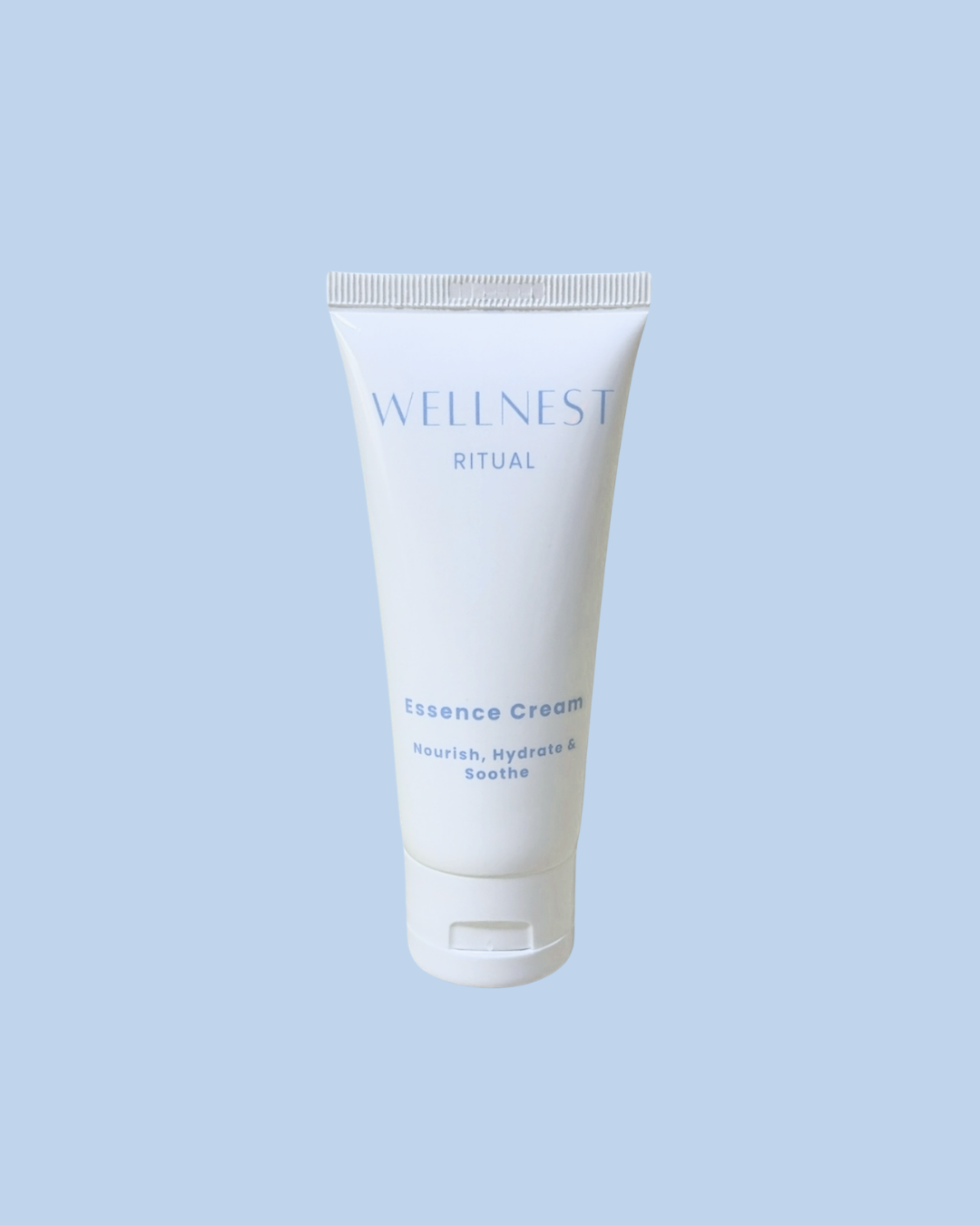 Tube of Wellness Ritual Essence Cream on a light blue background
